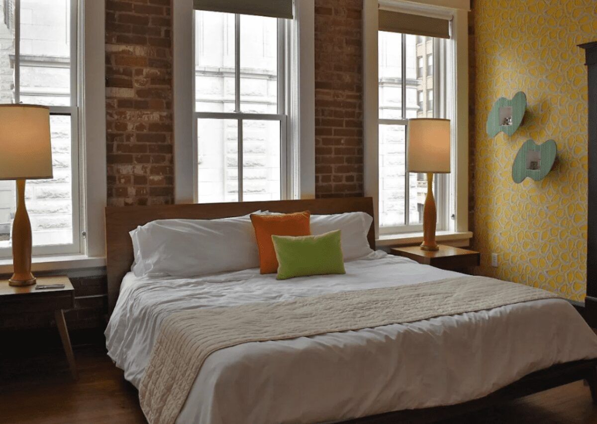 Hotel Bed with colorful decor and city views. Image: Dwell Hotel Travel Blog Finding Kathy Brown