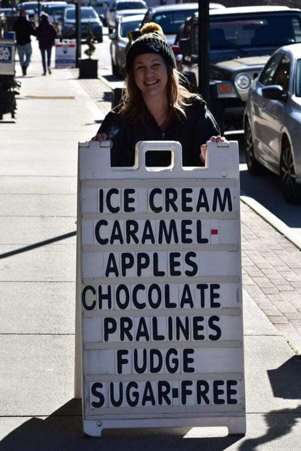 Bryson City, North Carolina. Travel and Lifestyle blogger Kathy Brown from Chattanooga, TN stands infront of an fudge sign in Bryson City.