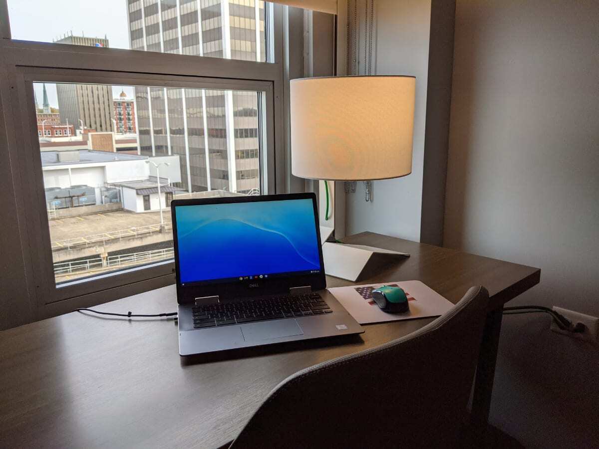 In hotel room desk with a view of Chattanooga downtown. Laptop computer set up next to a lamp. Image: Kathy Brown top Chattanooga Blogger working from a hotel room