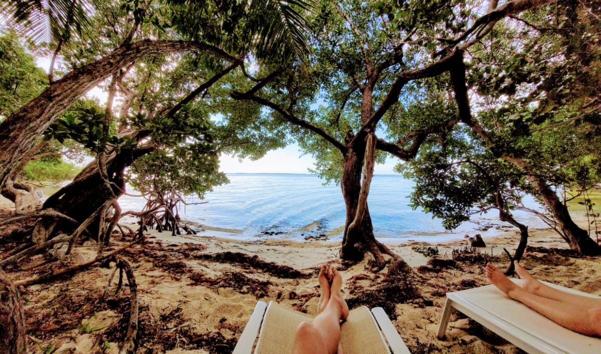 Private Hammock Beach Florida Bay Key Largo. Peaceful hammocks on a private beach two vacationers sitting looking at the calm waters