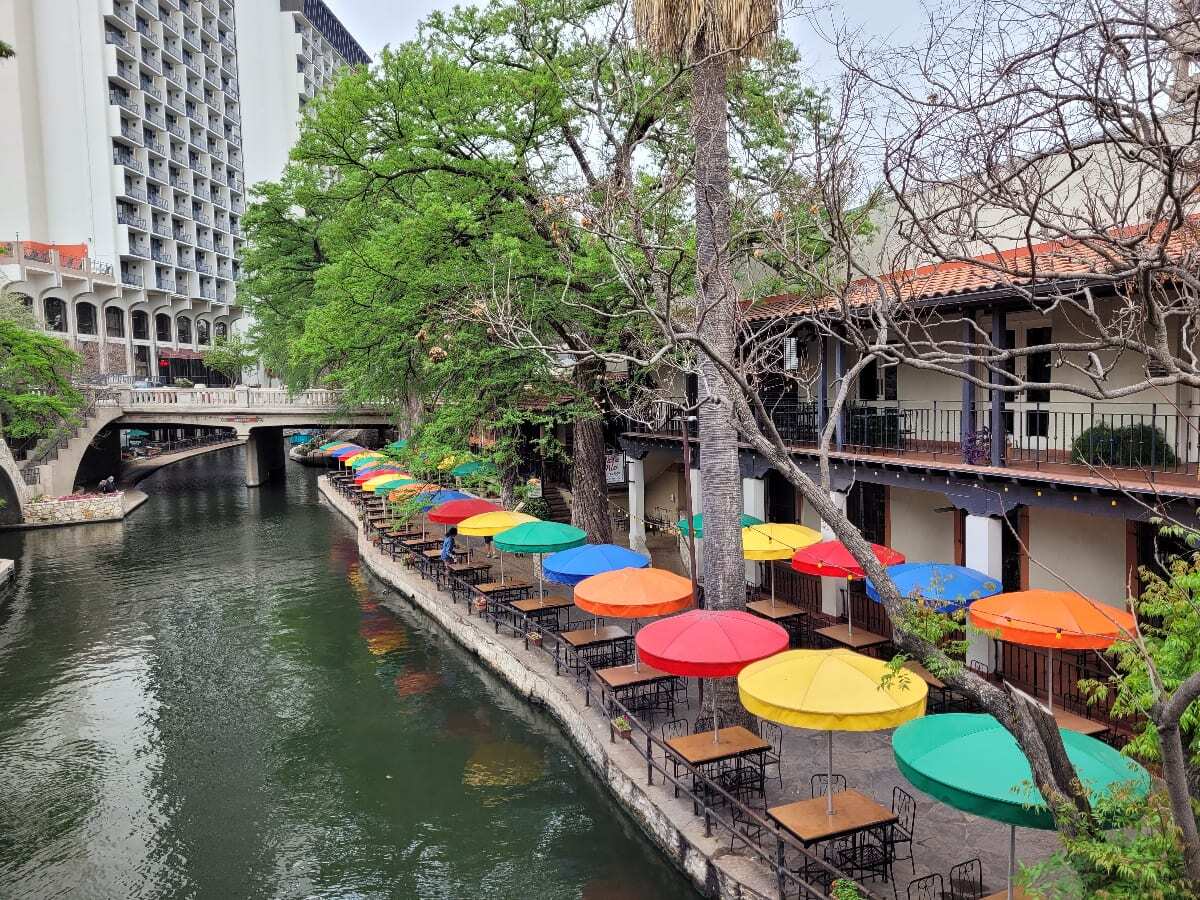 Daytime picture of colorful umbrella and Mexican restaurant on the river