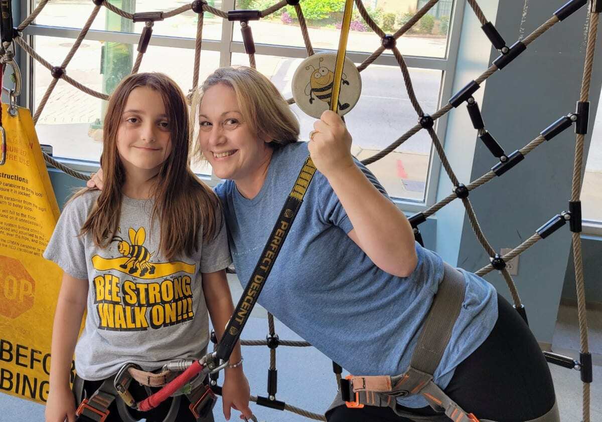 Chattanooga Blogger Kathy Brown and her granddaughter smiling for the camera as the are geared up for rock climbing.