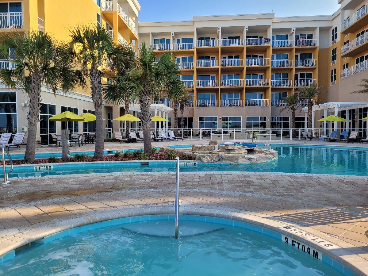 Relaxing poolside vibes abound at the Hilton Garden Inn in Fort Walton Beach, with plenty of loungers, umbrellas, and a lazy river for endless fun.