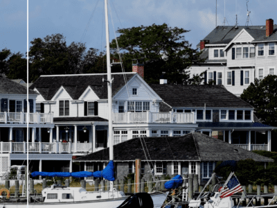 Canva Image of Martha Vineyard. Adorable small town setting. Boats docked in the Harbor. Historic homes line the shores.