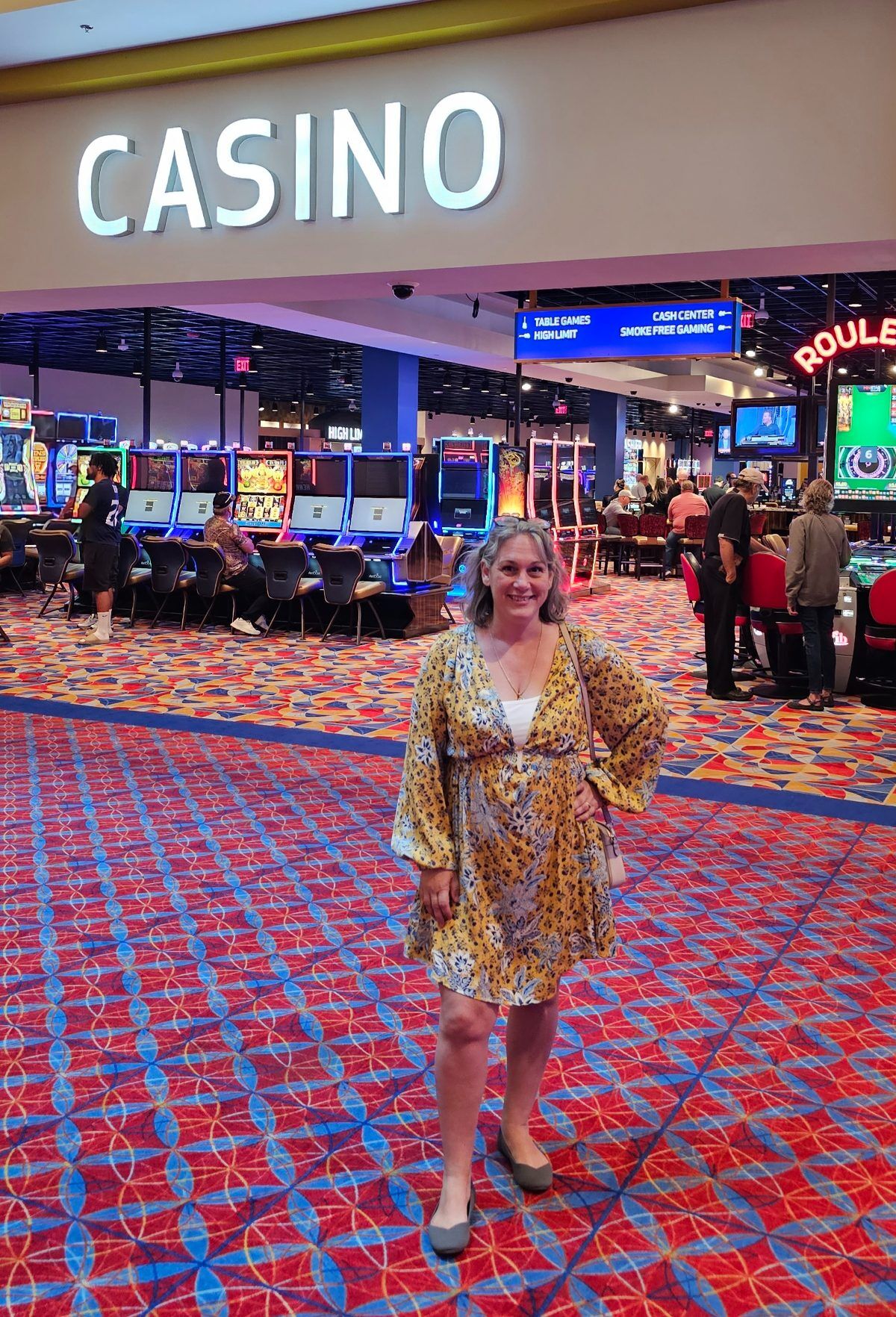 Tennessee Travel Blogger Kathy Brown standing infront of the Bristol Casino future home of the Hard Rock entrance. Kathy is dressed in Free People dress and looking excited to start gambling.