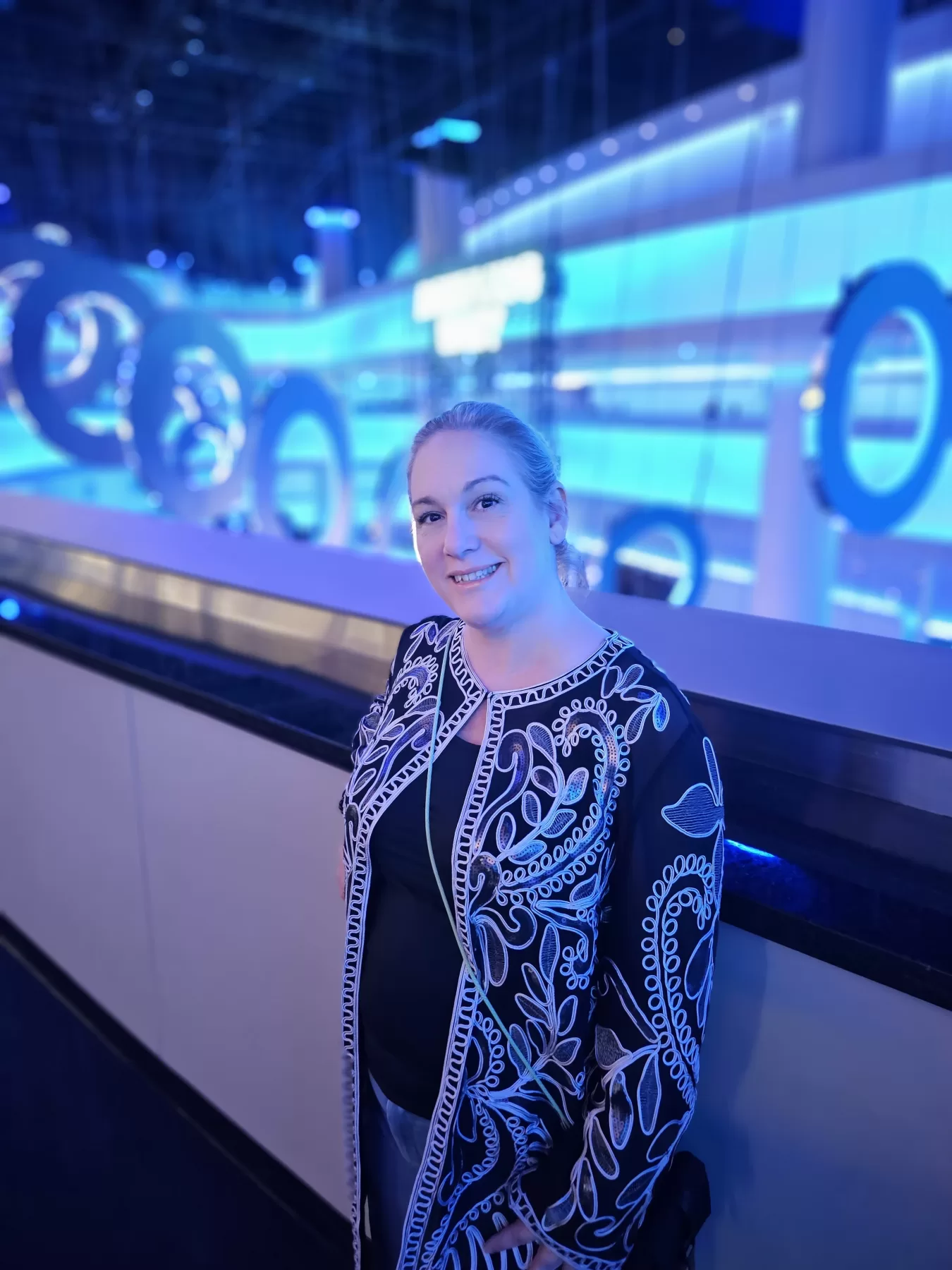 Midlife Travel Blogger Kathy Brown stands along the rail in the futuristic Las Vegas Sphere venue before the U2 concert.
