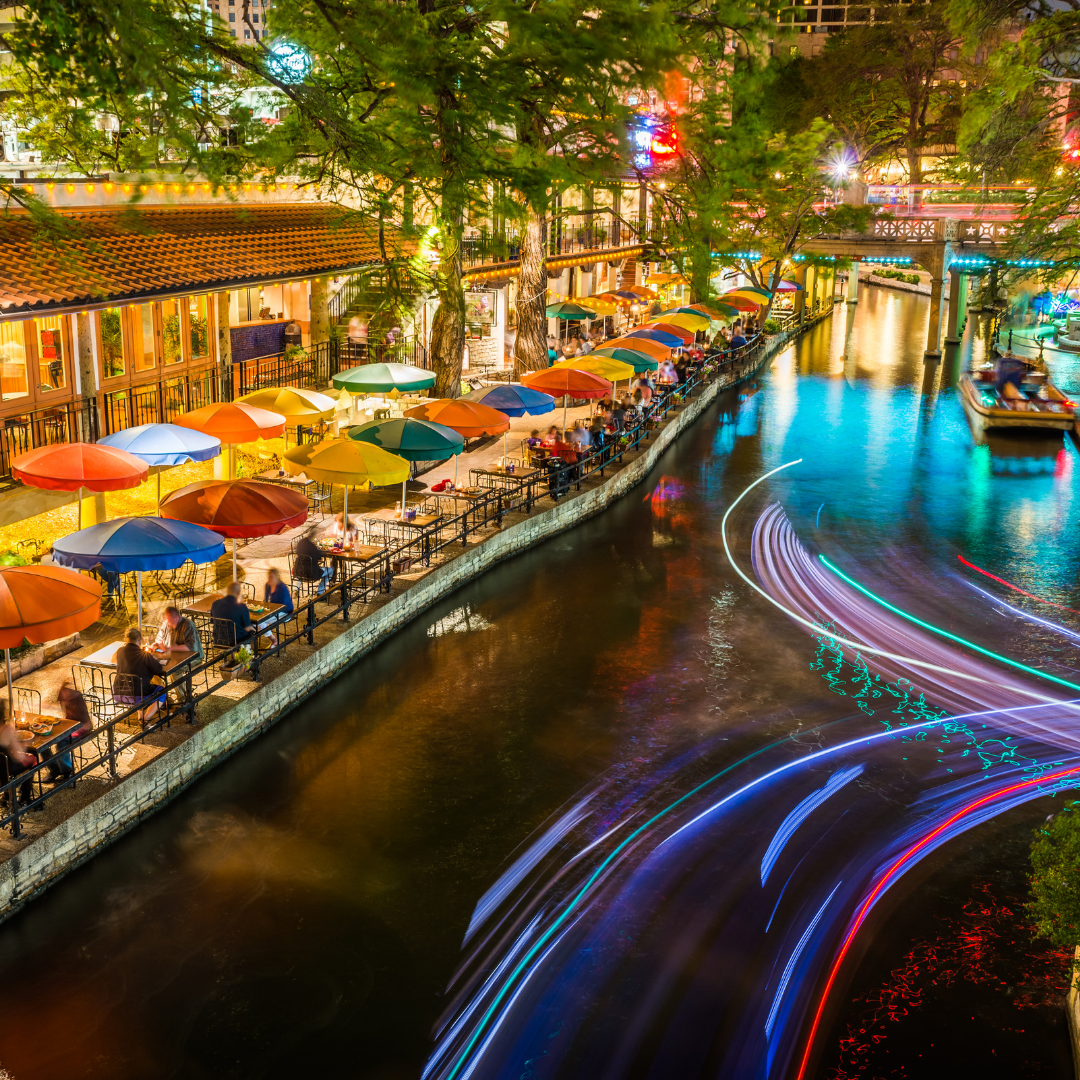 Mexican Restaurant on the San Antonio River Walk at night. Colorful lights and umbrellas