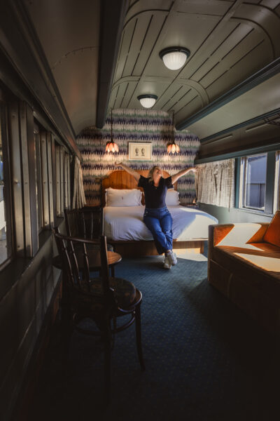 The Hotel Chalet Boutique Hotel Room inside a train car.  Retro feel as travel blogger Kathy Brown jumps for joy and has a great time vacationing in the scenic city of Tennessee.  Image Credit: CHRISTIAN MICHELLE PHOTOGRAPHY