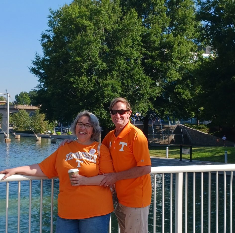 a man and woman standing on a bridge